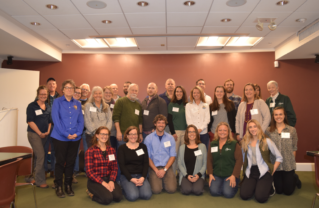 A group of people pose and smile for the camera. 